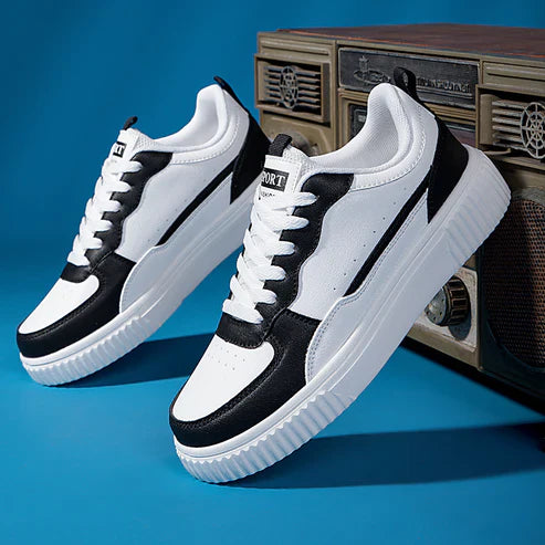 Black and white athletic sneakers with thick soles, displayed against a vintage radio backdrop. Stylish casual footwear for men and women.