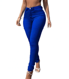 Woman wearing vibrant blue high-waisted skinny jeans and white strappy heels, showcasing 90s fashion style. Perfect for trendy denim outfit inspiration.