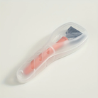 Plastic travel razor case with a pink handle and black blade, designed for safe and convenient storage. Ideal for travel and personal grooming.