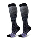 Black and gray gradient compression socks with striped pattern, knee-high design, ideal for sports, travel, and circulation support.