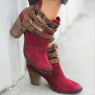 Red suede ankle boots with brown leather straps and chunky wooden heels, stylish women's footwear, fashion-forward design, casual chic boots.