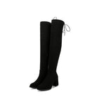 Black over-the-knee boots with block heels and back tie detail, stylish women's footwear, perfect for fall fashion and versatile outfit pairing.