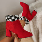 Red suede ankle boots with chunky heels and black-and-white plaid fur trim, perfect for winter fashion. Stylish women's footwear, cozy and chic.