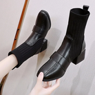 Black leather ankle boots with ribbed knit sock design, block heels, and sleek stitching. Stylish women's footwear for fall fashion trends.