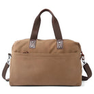 Tan canvas duffel bag with brown leather handles and detachable shoulder strap, featuring a front pocket. Ideal for travel and weekend getaways.