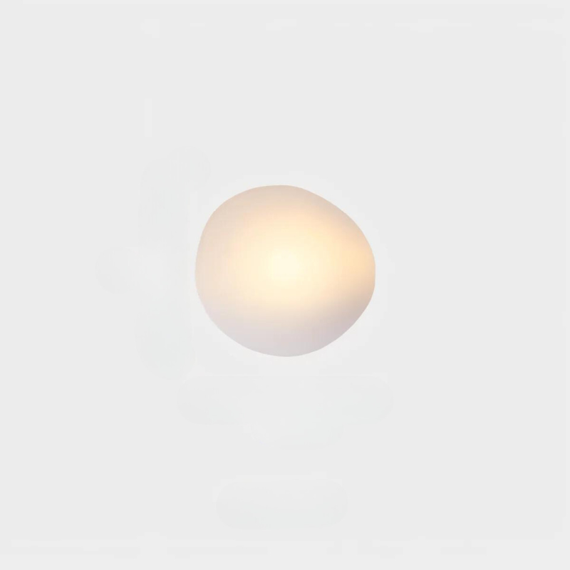 Modern minimalist wall sconce with soft white glow, ideal for contemporary home lighting. Energy-efficient LED light fixture for ambient illumination.