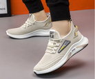 Stylish beige athletic sneakers with breathable mesh design, cushioned sole, and modern accents, ideal for running and casual wear.