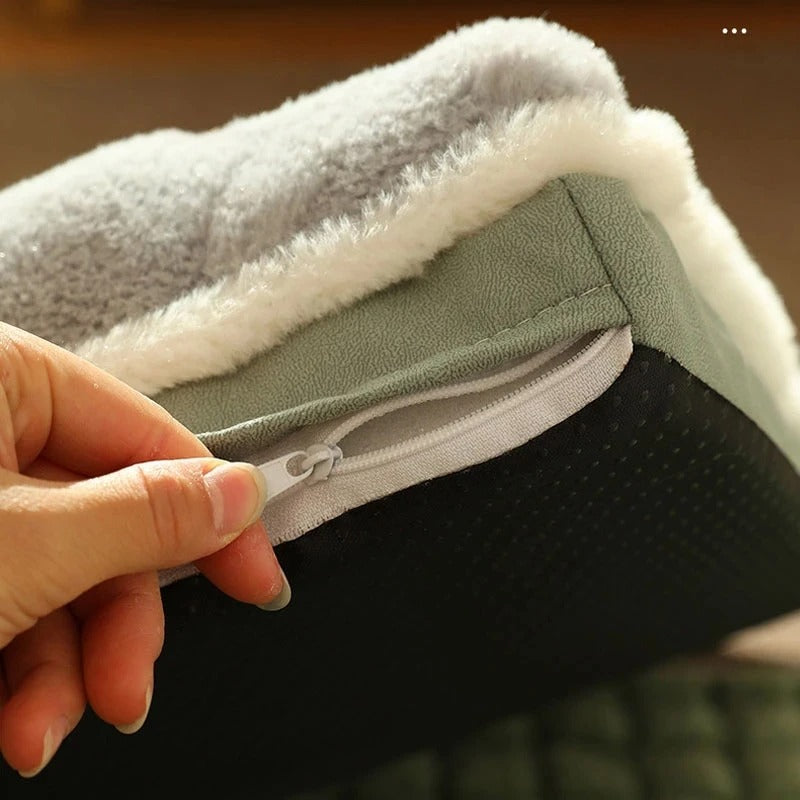 Close-up of a hand opening a zippered, plush pet bed with a soft, gray fleece lining and non-slip bottom, ideal for dog and cat comfort.