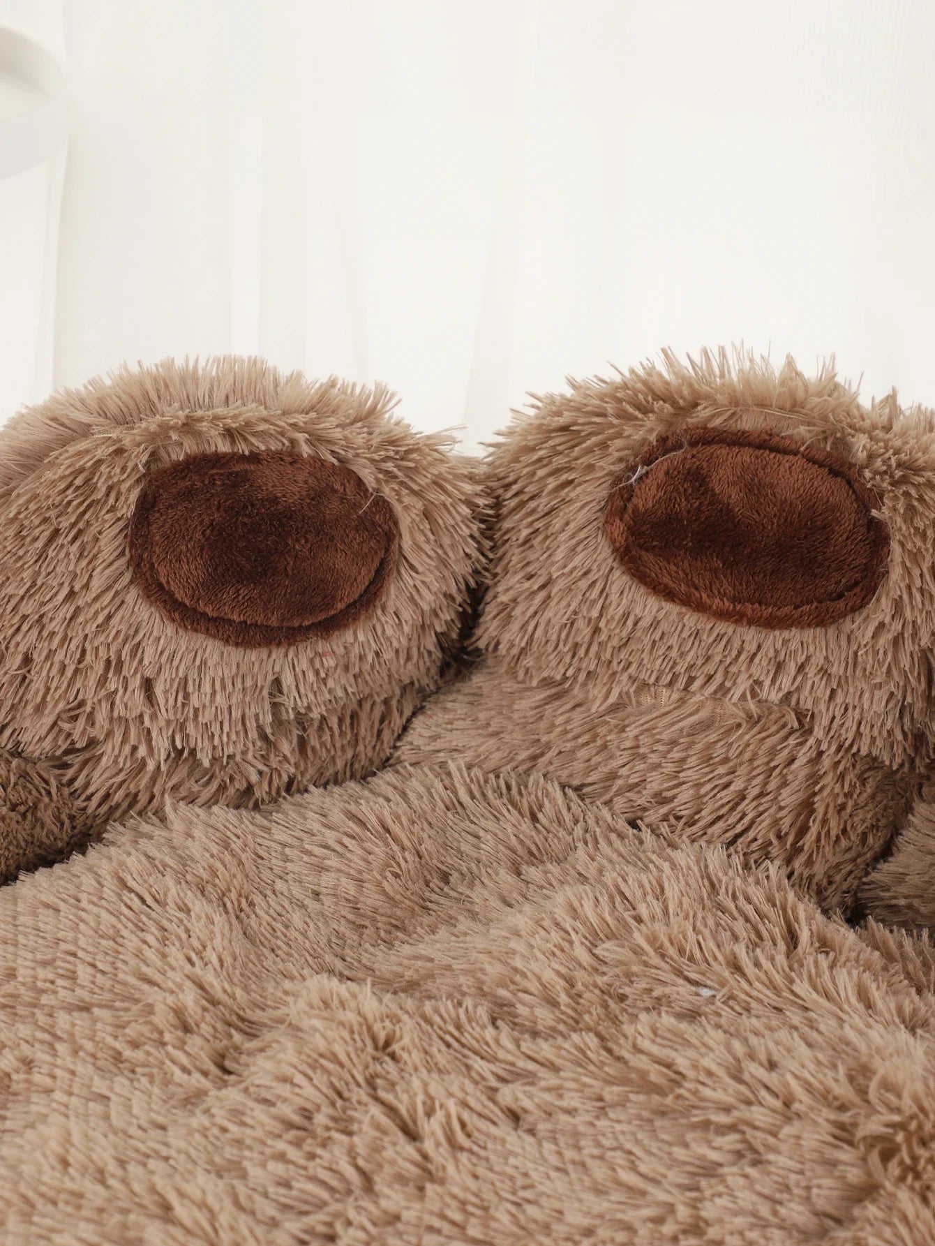 Fluffy brown bear paw slippers, plush indoor footwear, cozy and warm, perfect for lounging.