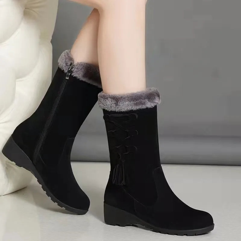 Black mid-calf snow boots with faux fur trim, side zipper, and lace-up detail. Women's winter footwear, mid-heel, plush lining, trendy design.