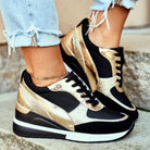 Stylish black and gold orthopedic sneakers on feet with frayed jeans, showcasing comfort and fashion. Perfect for pain-free walking.