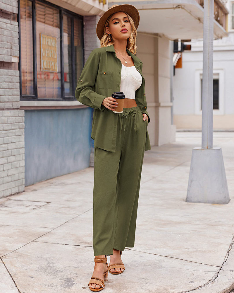 Woman in stylish army green two-piece outfit with wide-leg pants and button-up shirt, holding coffee. Fashionable street style, casual chic look.