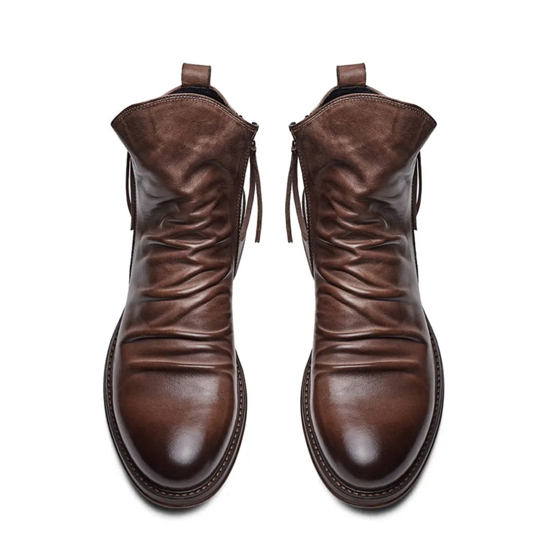 Brown leather ankle boots with side zippers, featuring a sleek design and polished finish. Perfect for men's fashion and casual wear.