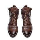 Brown leather ankle boots with side zippers, featuring a sleek design and polished finish. Perfect for men's fashion and casual wear.