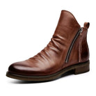 Brown leather ankle boot with side zipper, low heel, and smooth finish. Stylish men's footwear, perfect for casual and formal occasions.