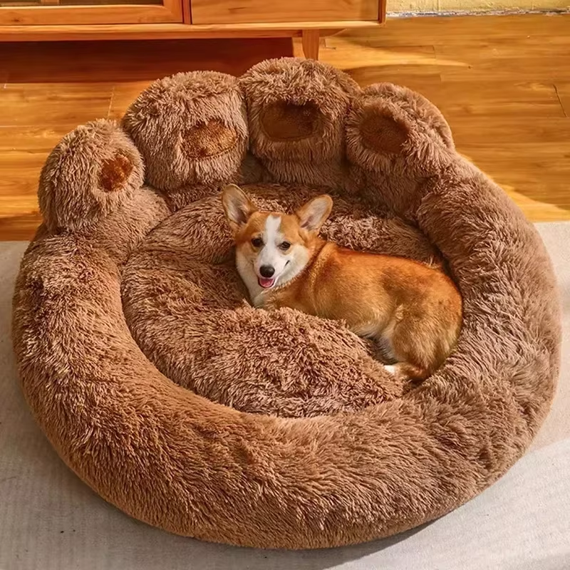 Corgi resting in a large, plush, paw-shaped dog bed on a wooden floor. Cozy pet furniture, comfortable dog bed, luxury pet accessories.