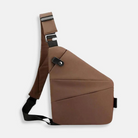 Brown crossbody sling bag with adjustable strap, modern geometric design, and secure buckle closure. Ideal for travel and daily use.