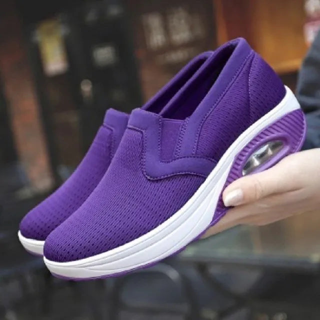 Purple orthopedic women's sneakers with breathable mesh, slip-on design, and cushioned sole for diabetic comfort. Ideal walking shoes.