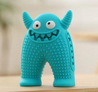 Blue monster-shaped dog chew toy with textured surface, durable rubber, and playful design. Ideal for pet dental health and interactive play.