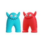 Colorful monster-shaped dog chew toys in blue and red, featuring textured surfaces for dental health. Durable, fun pet accessories for playful dogs.