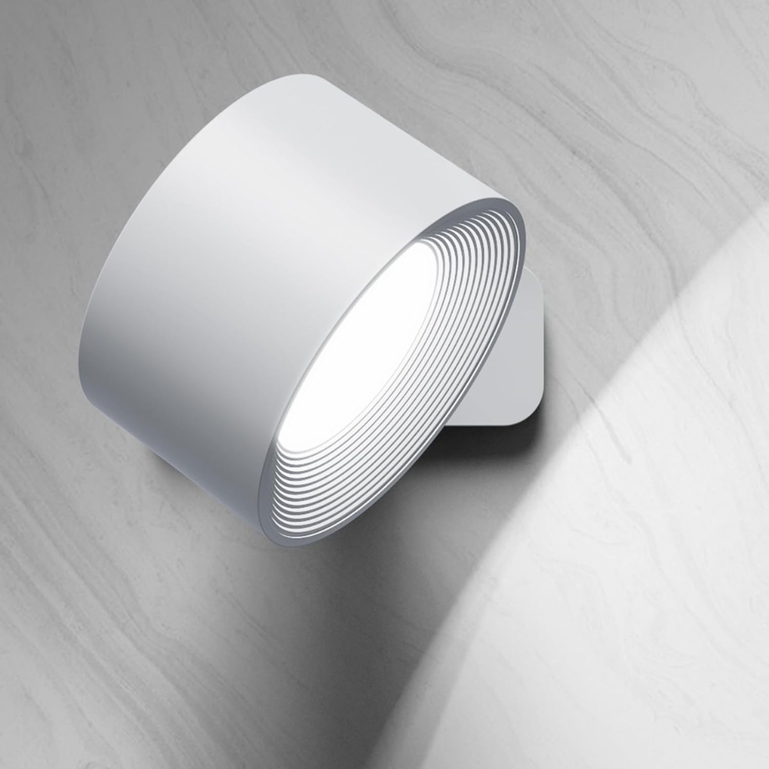 Modern white wall sconce with circular design, LED light, and minimalist aesthetic, ideal for contemporary home lighting and interior decor.