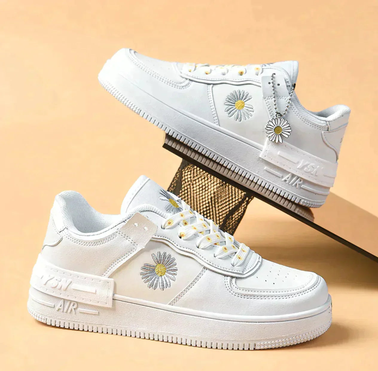 White sneakers with embroidered daisy design, featuring a stylish platform sole. Trendy casual footwear for men and women. Fashionable streetwear shoes.