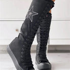 Black knee-high lace-up sneakers with star embellishment, featuring a sleek design and comfortable fit. Perfect for casual and trendy fashion styles.