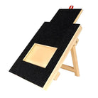 Dog scratch board with treat holder, wooden frame, black sandpaper surface, adjustable stand. Ideal for nail filing, pet grooming, training tool.