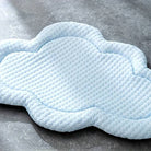 Cloud-shaped cooling dog mat on a gray surface, textured light blue design, ideal for pet comfort and temperature regulation.