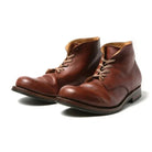 Brown leather men's boots with laces, featuring a classic design and durable sole. Perfect for casual and formal wear. High-quality footwear.