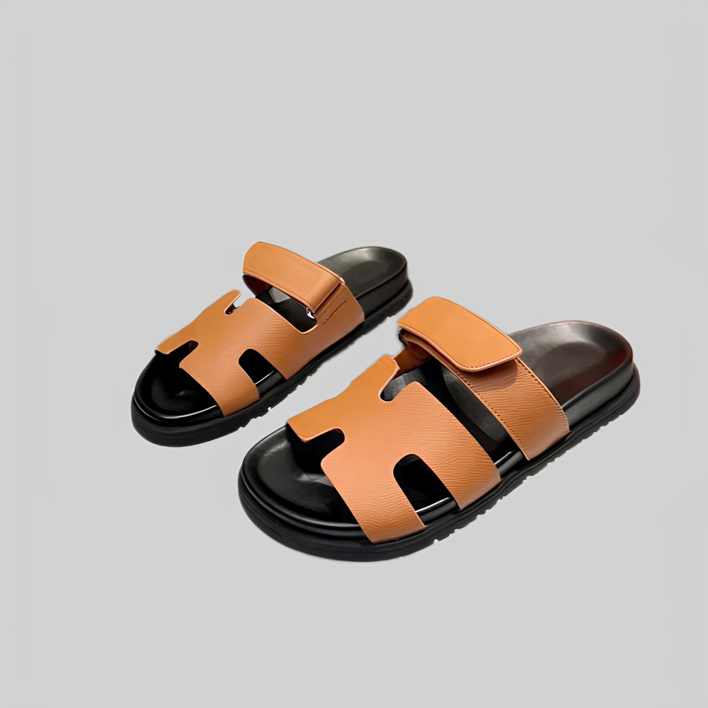 Brown leather sandals with black soles, featuring adjustable straps and open-toe design, perfect for casual summer wear. Comfortable and stylish footwear.