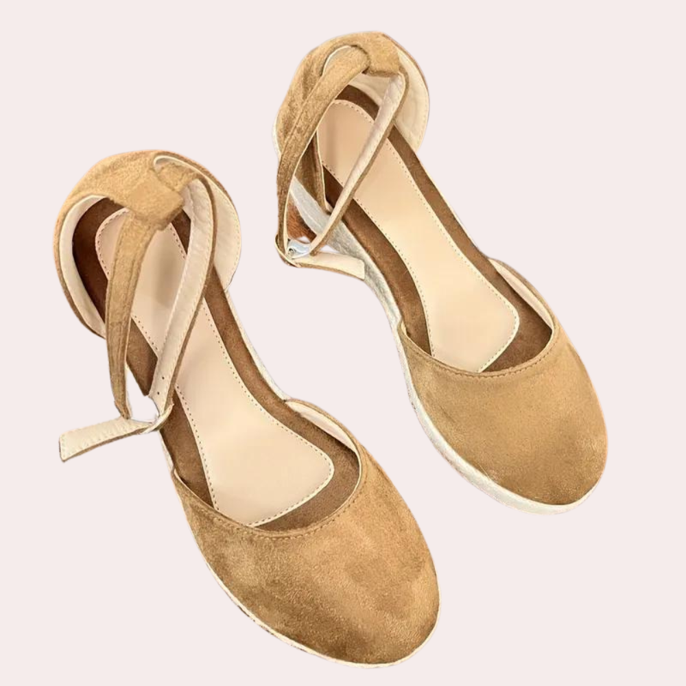 Women's brown suede espadrille sandals with ankle strap, beige insole, and white sole. Stylish summer footwear, perfect for casual outfits.