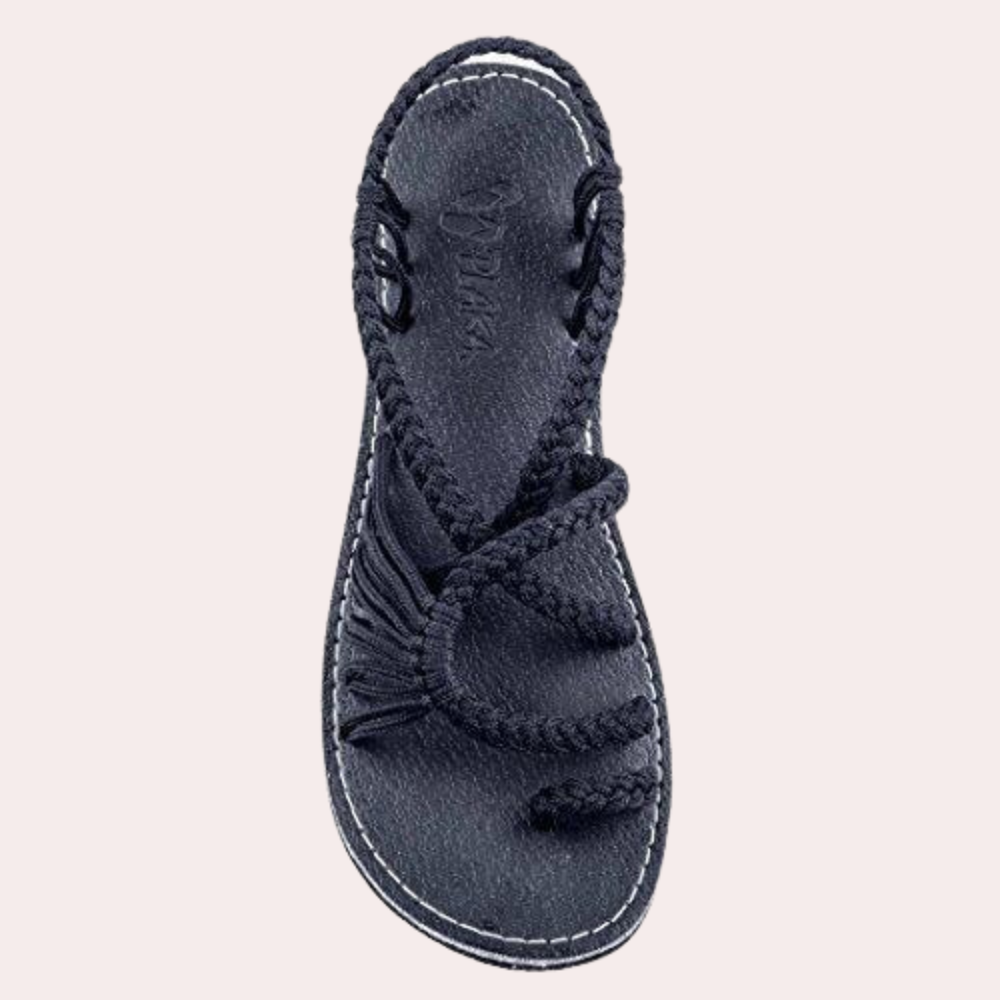 Black braided rope sandal with open toe design, durable sole, and intricate strap pattern. Ideal for casual summer wear. Women's footwear.