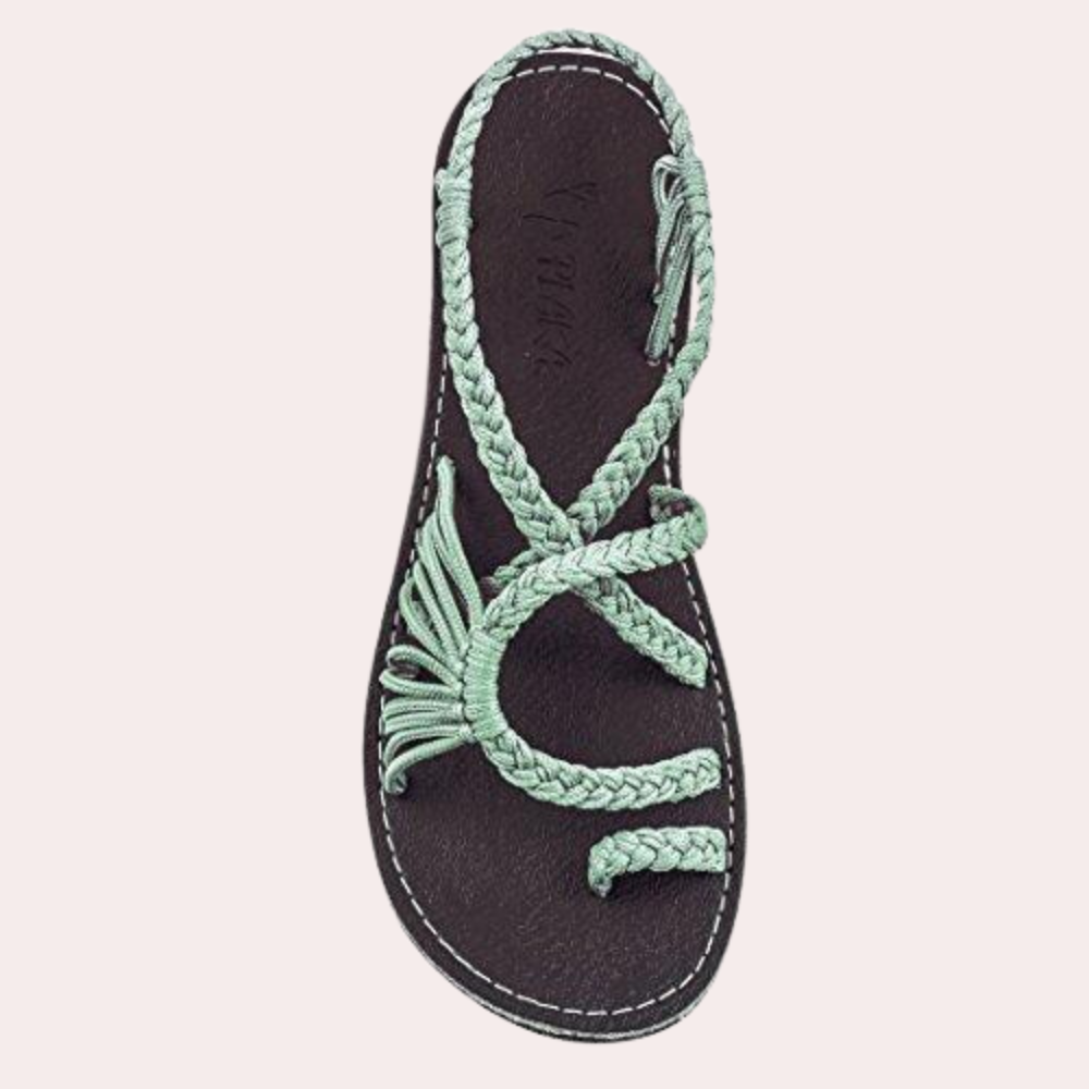 Women's braided sandal with mint green straps and black sole, perfect for summer fashion. Comfortable, stylish footwear for casual wear.