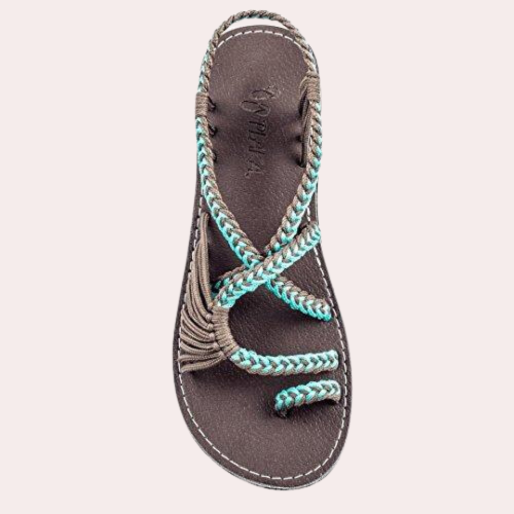 Women's braided sandal in blue and gray, featuring a durable sole and stylish crisscross straps. Perfect for casual summer wear and beach outings.