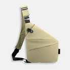 Cream-colored crossbody sling bag with adjustable strap, modern geometric design, and secure buckle closure. Ideal for travel and daily use.