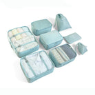 Light blue travel packing cubes set with various sizes, including mesh compartments and zippered pouches, ideal for organized luggage and efficient packing.