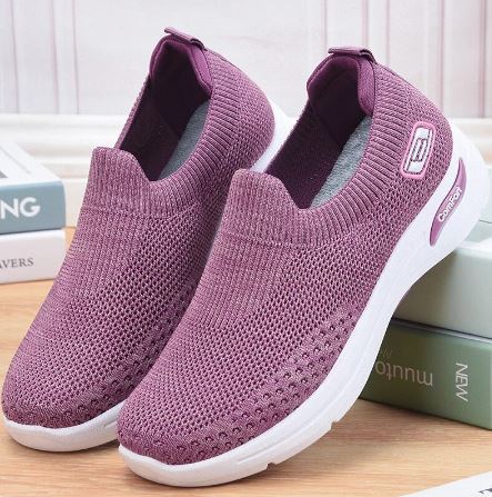 Purple slip-on sneakers with breathable knit upper, white sole, and logo detail, perfect for casual wear and walking comfort.