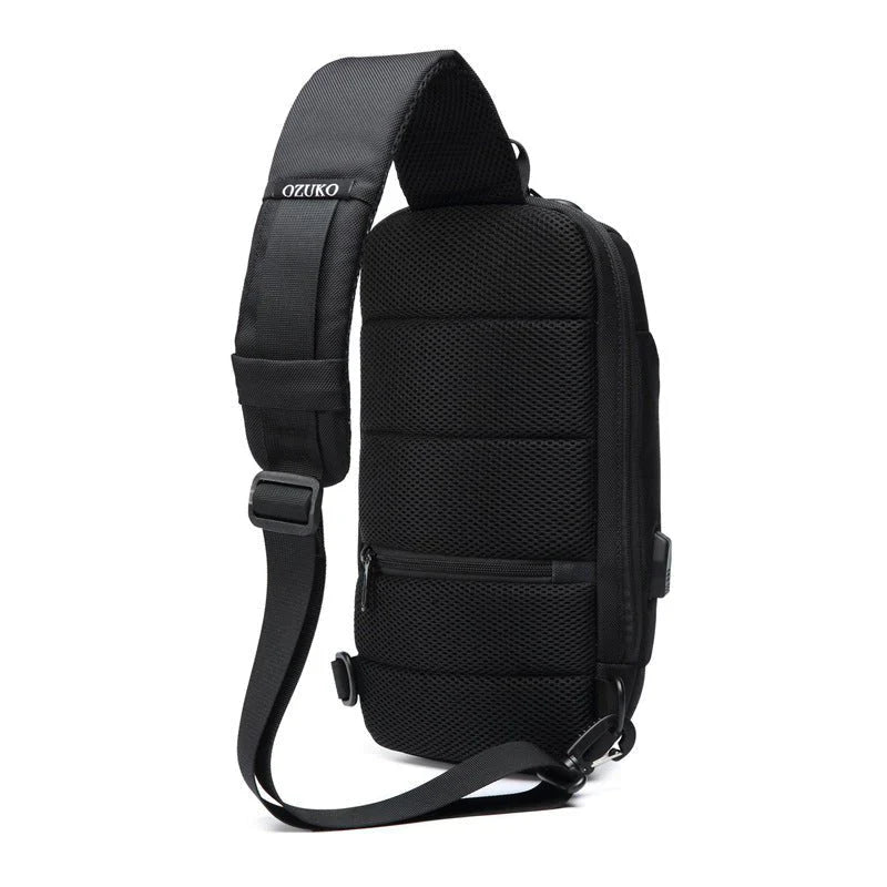 Black Ozuko sling backpack with adjustable strap, front zipper pocket, and padded design. Ideal for travel, urban commuting, and daily use.