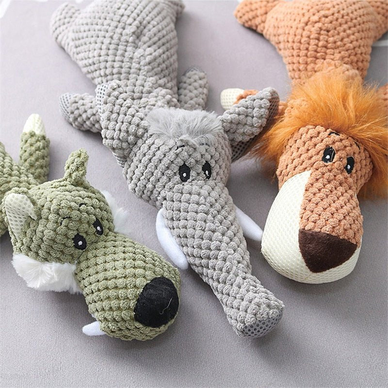 Plush dog toys in animal shapes, featuring a green wolf, gray elephant, and brown lion, perfect for interactive pet play and chew sessions.