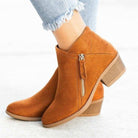 Women's brown suede ankle boots with side zipper, low block heel, and cushioned footbed. Stylish and comfortable footwear for casual outfits.