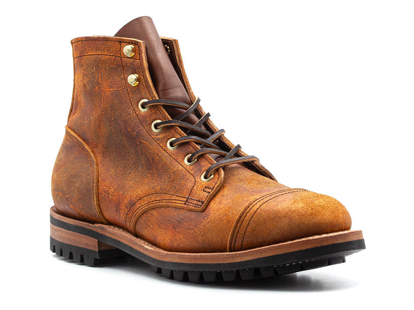 Brown leather men's boot with rugged design, lace-up closure, and durable sole. Perfect for outdoor wear. High-quality craftsmanship.