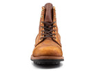 Front view of a brown leather Coach Rambler boot with black laces, rugged sole, and brass eyelets, ideal for men's fashion and outdoor wear.