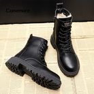 Black leather ankle boots with plush lining, platform sole, and lace-up design. Stylish British winter footwear, perfect for warmth and fashion.