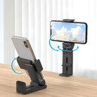 Adjustable smartphone stand holder on a wooden desk, showcasing 360-degree rotation and multi-angle viewing for hands-free mobile device use.