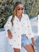 Women's white cotton shirt with red heart embroidery, crinkle texture, long sleeves, casual loose fit. Perfect for spring fashion 2023.