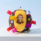 Colorful polka dot squeaky ball pet toy with embroidered monkey design and ribbon tags, perfect for playful pets.