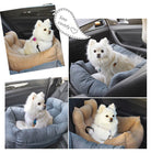 Small white dog in a cozy car seat for pets, featuring plush cushioning and secure straps. Ideal for pet travel safety and comfort in vehicles.