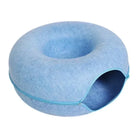 Blue donut-shaped cat bed with tunnel entrance, scratch-resistant felt material. Perfect cozy pet house for cats. Interactive and durable design.