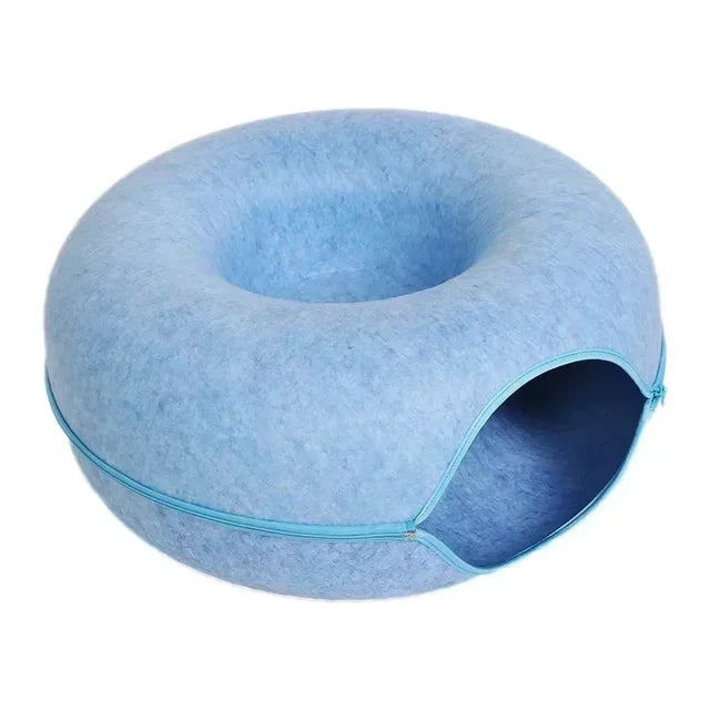 Blue donut-shaped cat bed with tunnel entrance, scratch-resistant felt material. Perfect for interactive pet play and cozy cat sleeping.